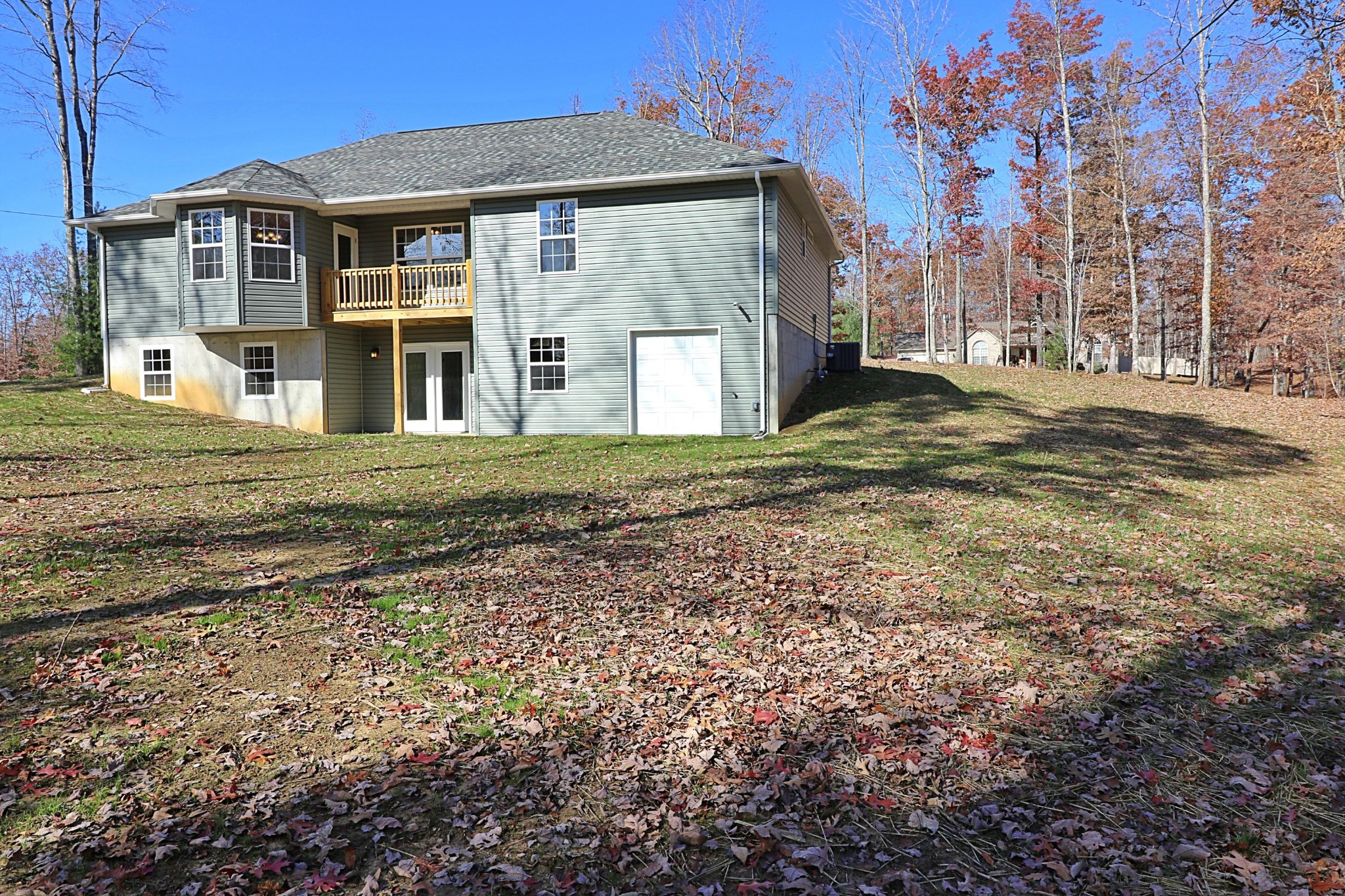 391 Toomey Falls Road Oneida, TN 37841 - Photo 39 of 42 a view of a big house with a yard and large trees