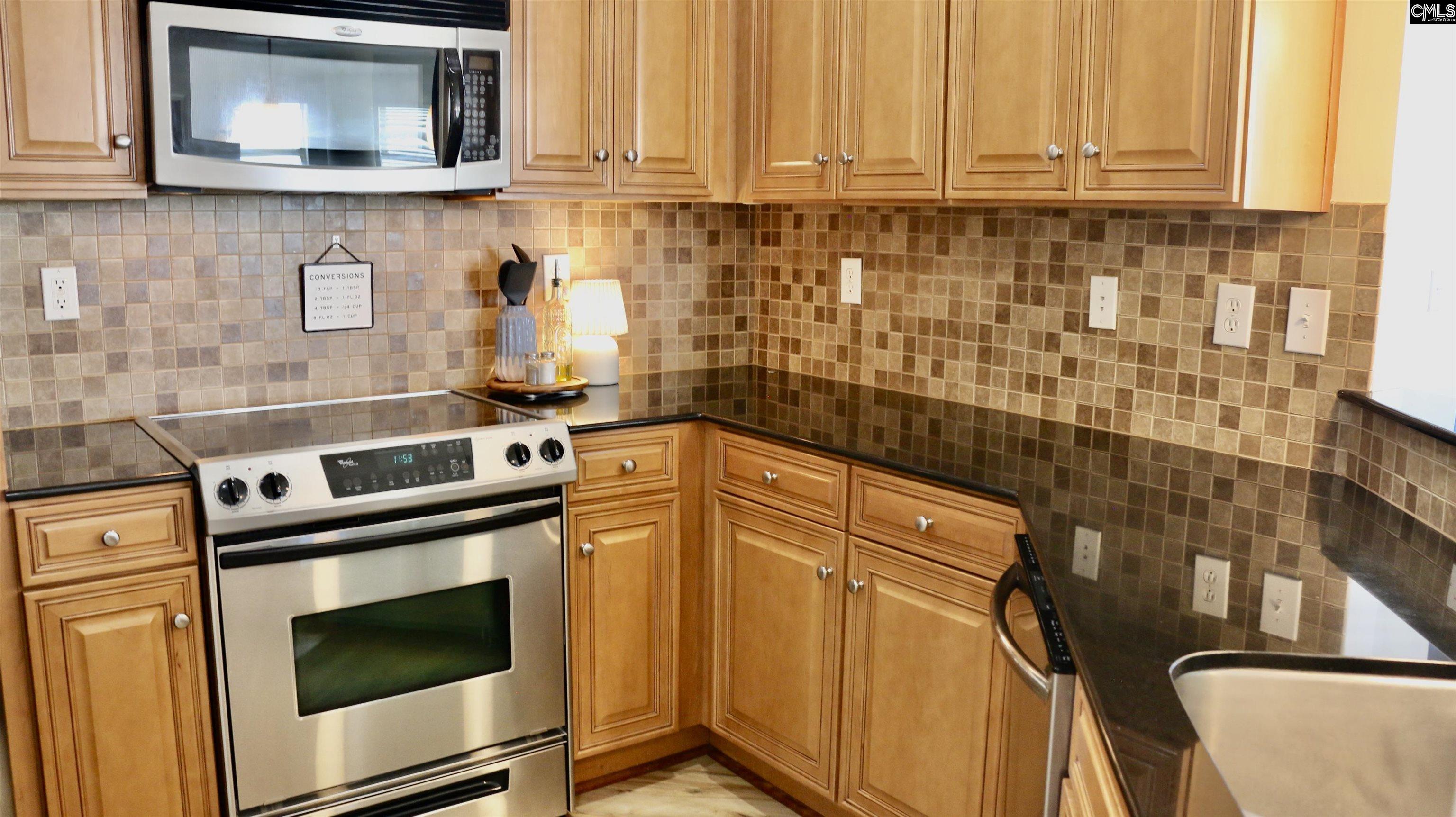 601 Main Street, Unit 323 Columbia, SC 29201 - Photo 14 of 68 a kitchen with stainless steel appliances granite countertop a stove and a microwave