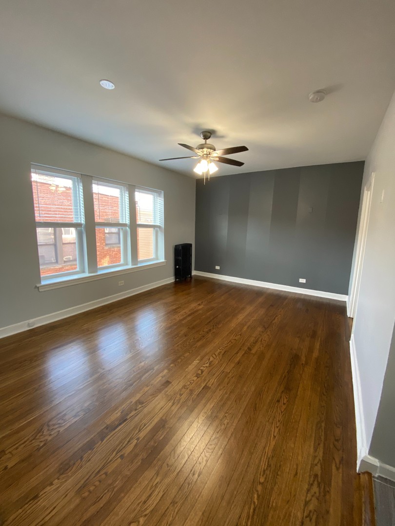 1722 West Juneway Terrace, Unit 3B Chicago, IL 60626 - Photo 2 of 9 a view of an empty room with window and wooden floor