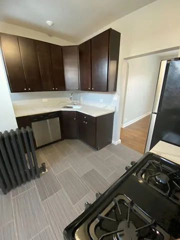 a kitchen with a sink appliances and cabinets