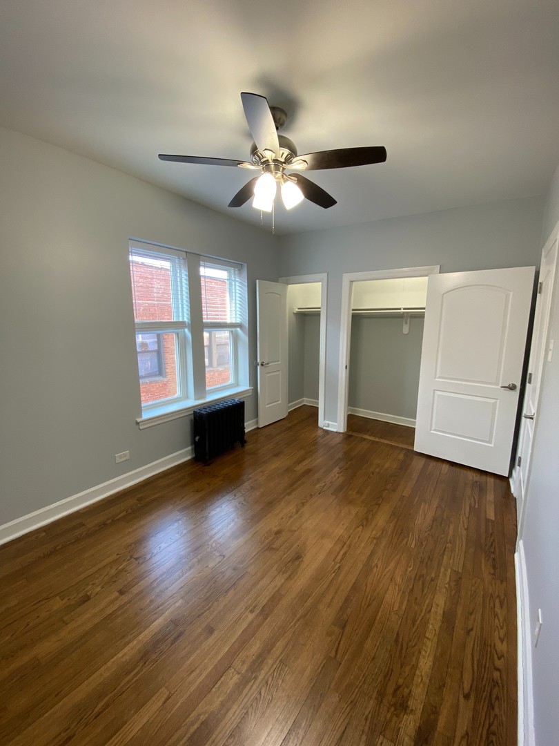 1722 West Juneway Terrace, Unit 3B Chicago, IL 60626 - Photo 6 of 9 a view of an empty room with a window and wooden floor