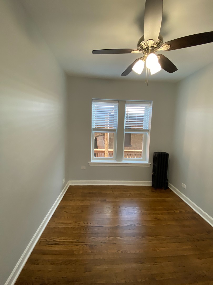 1722 West Juneway Terrace, Unit 3B Chicago, IL 60626 - Photo 8 of 9 a view of an empty room with a window and wooden floor