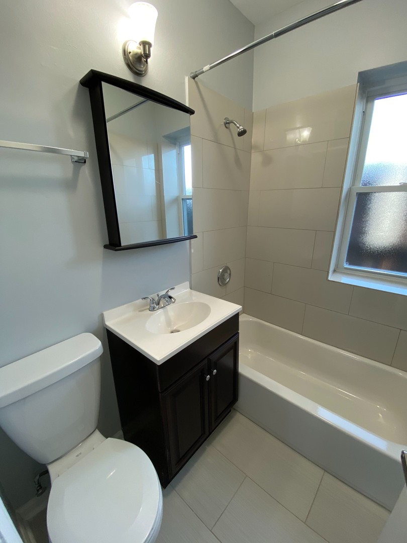 1722 West Juneway Terrace, Unit 3B Chicago, IL 60626 - Photo 9 of 9 a bathroom with a sink toilet and shower
