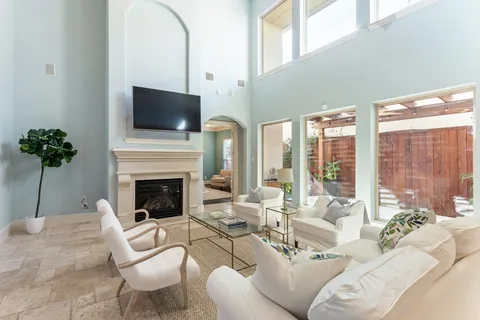 a living room with furniture a fireplace and a flat screen tv