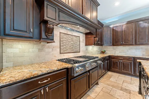 a kitchen with stainless steel appliances granite countertop a stove and a sink