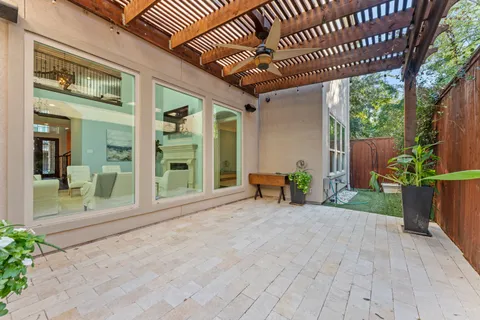 a view of a porch with wooden floor and outdoor seating