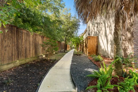 a view of a pathway with a garden