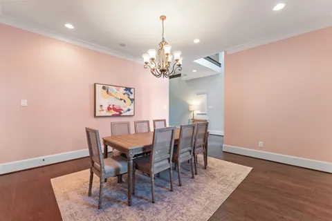 a view of a dining room with furniture and chandelier