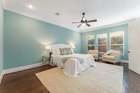 a bedroom with a large bed and a chandelier