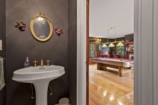 a view of a big house with a big yard and large trees