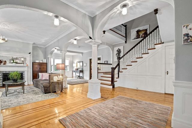 a view of entryway and hall with wooden floor