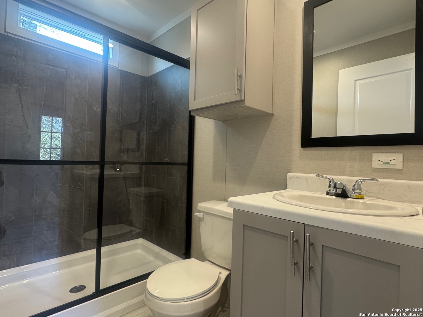 213 West White Street Pleasanton, TX 78064 - Photo 6 of 7 a bathroom with a sink a toilet and shower