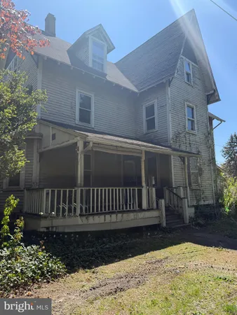 a view of a house with a wooden fence