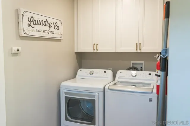a large white kitchen with cabinets