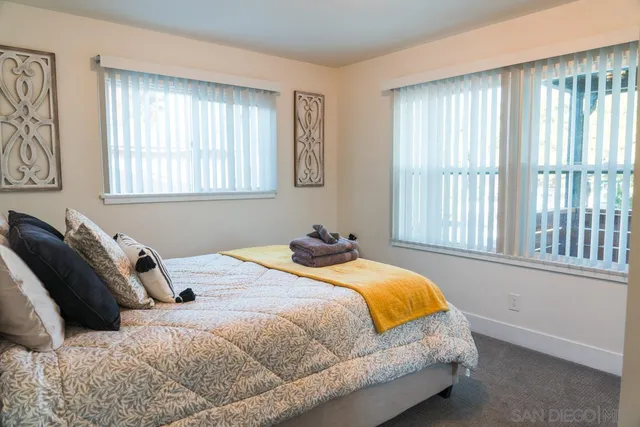 a bathroom with a toilet sink vanity shower and mirror