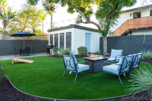 a living room with furniture a flat screen tv and a potted plant