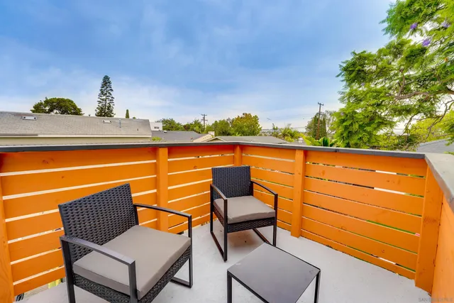 a living room with furniture a window and a potted plant