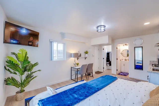 a bedroom with a bed and a chandelier