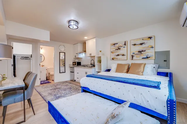 a bedroom with a large bed and a chandelier