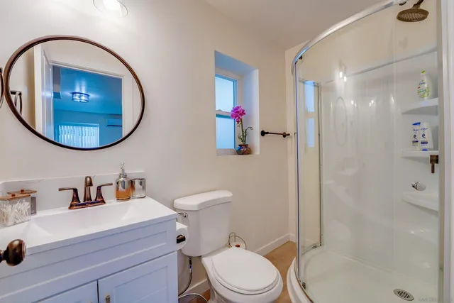 a view of a chair and table in backyard of the house
