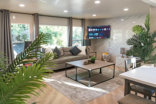 a kitchen with stainless steel appliances kitchen island granite countertop a kitchen island hardwood floor and a sink