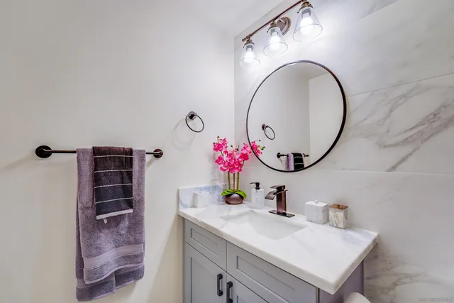 a kitchen with stainless steel appliances granite countertop a stove a refrigerator a oven a sink a island a dining table and chairs with wooden floor