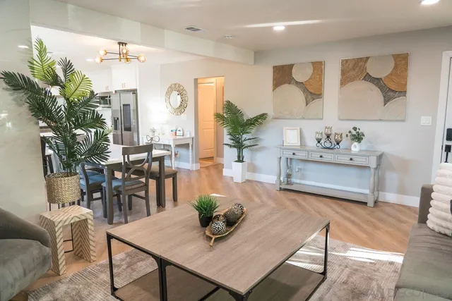 a view of a dining room with furniture a chandelier and wooden floor