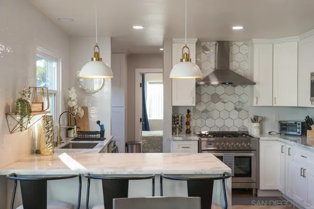 a bedroom with a bed a lamp and a large window