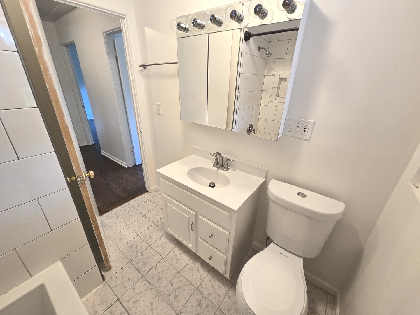 901 East Krage Drive Addison, IL 60101 - Photo 13 of 25 a white toilet sitting next to a bathroom sink