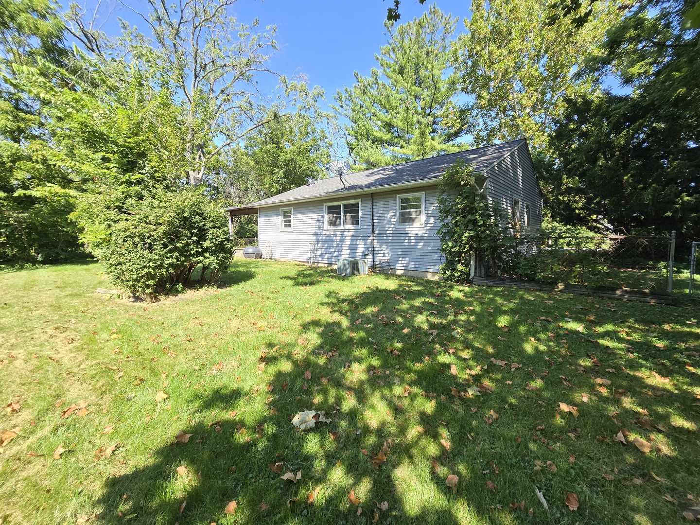 901 East Krage Drive Addison, IL 60101 - Photo 22 of 25 a backyard of a house with large trees and plants