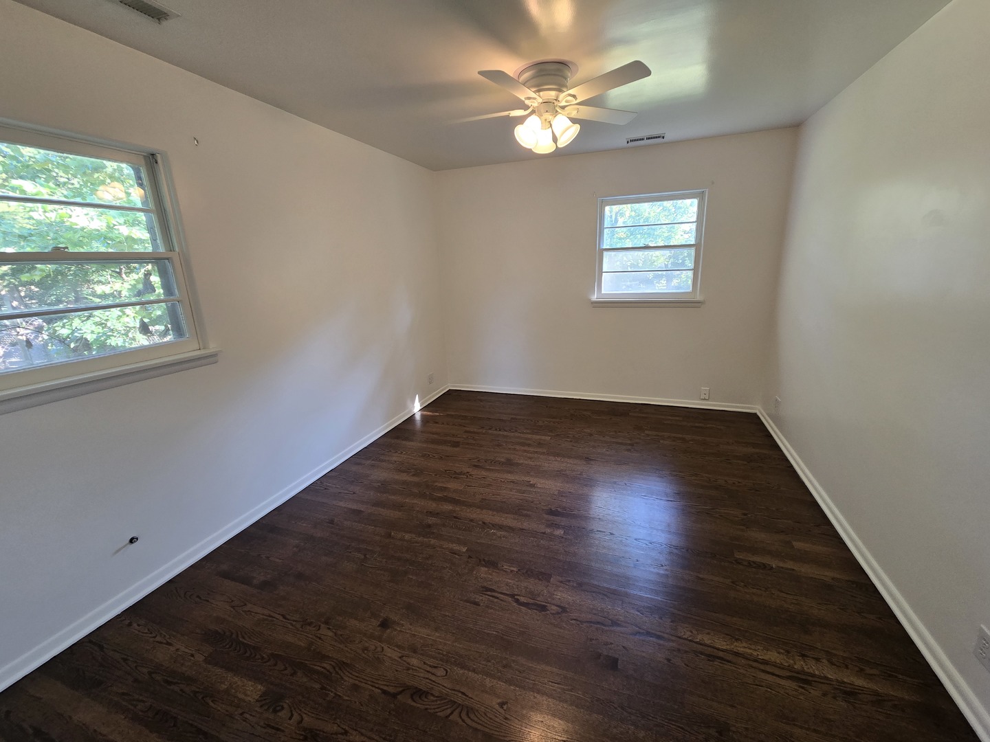901 East Krage Drive Addison, IL 60101 - Photo 6 of 25 an empty room with wooden floor and windows