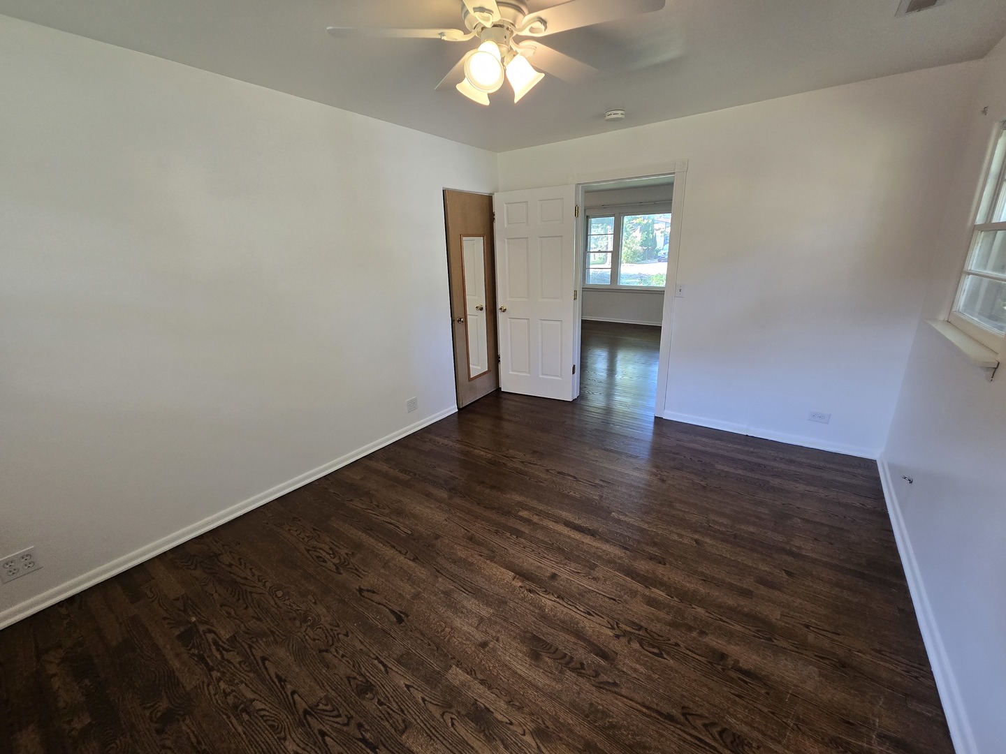 901 East Krage Drive Addison, IL 60101 - Photo 7 of 25 a view of an empty room with window and wooden floor