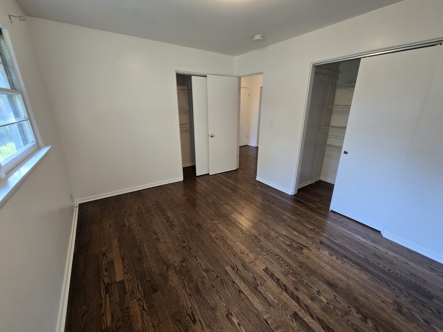 901 East Krage Drive Addison, IL 60101 - Photo 9 of 25 a view of an empty room with wooden floor and a window