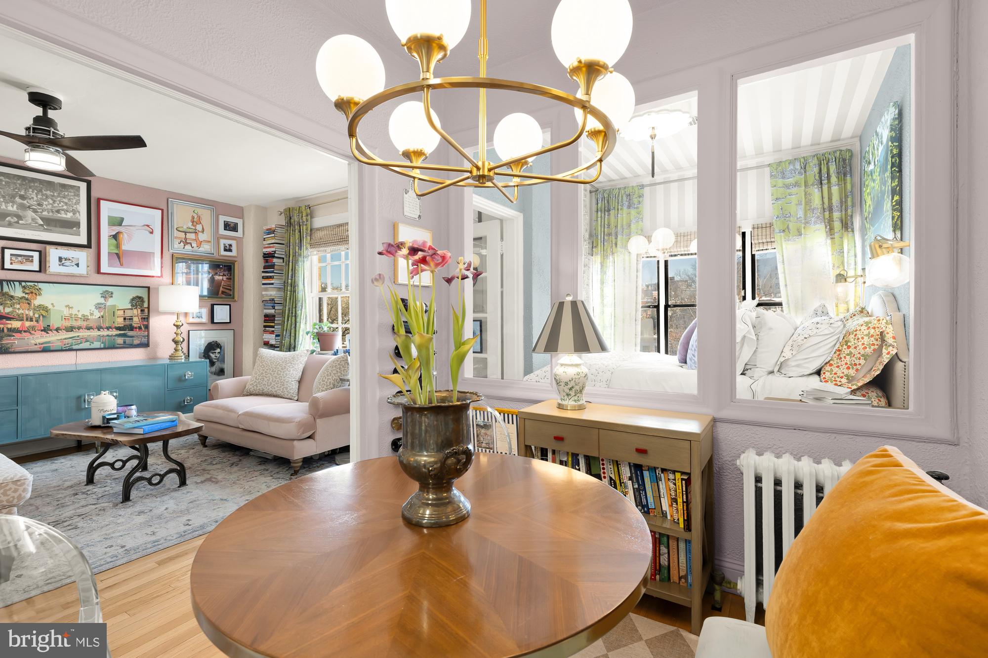 2040 Belmont Road Northwest, Unit 628 Washington, DC 20009 - Photo 11 of 19 a living room with furniture a chandelier and a large mirror
