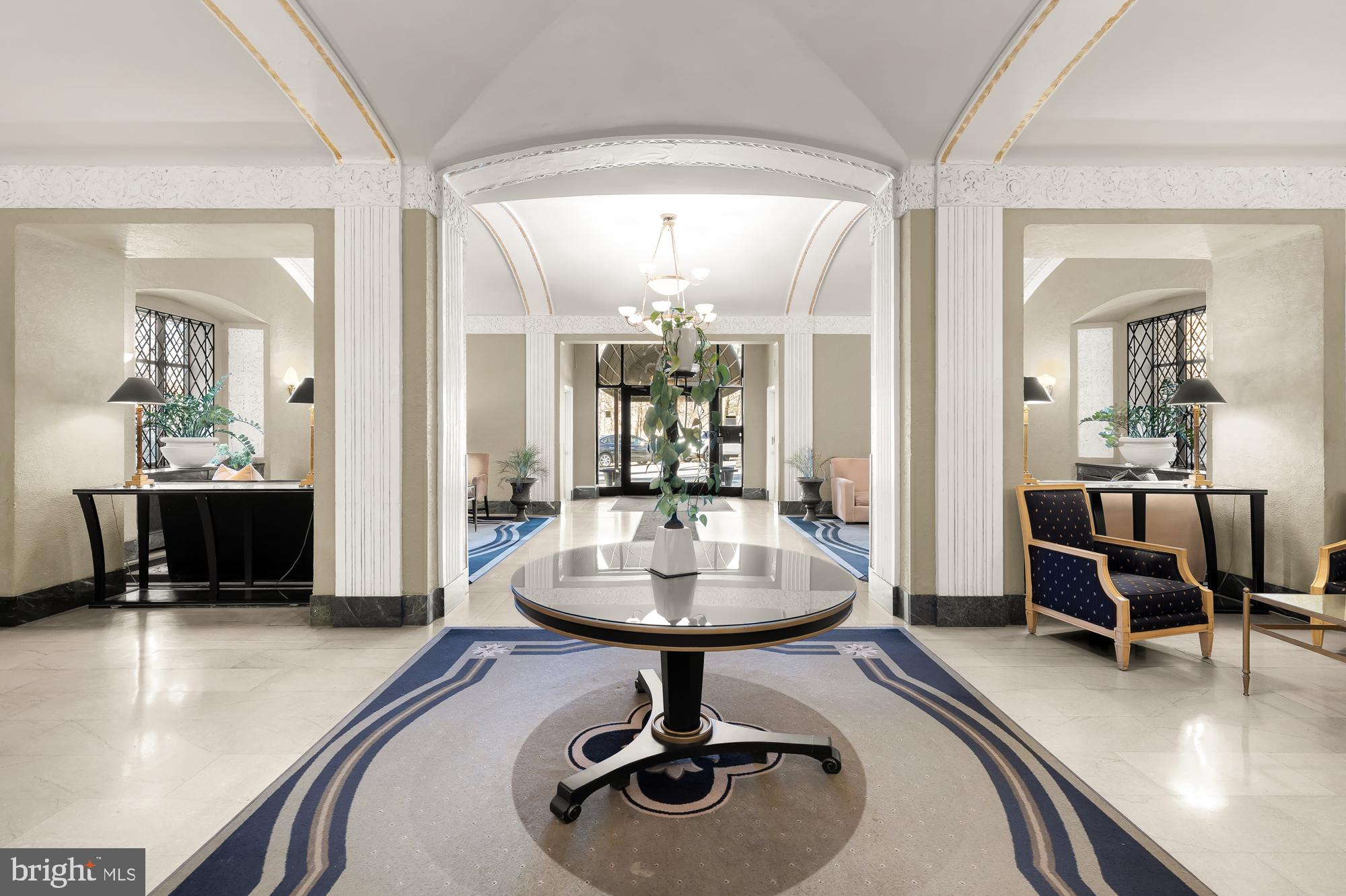 2040 Belmont Road Northwest, Unit 628 Washington, DC 20009 - Photo 15 of 19 a dining room with wooden floor and a chandelier