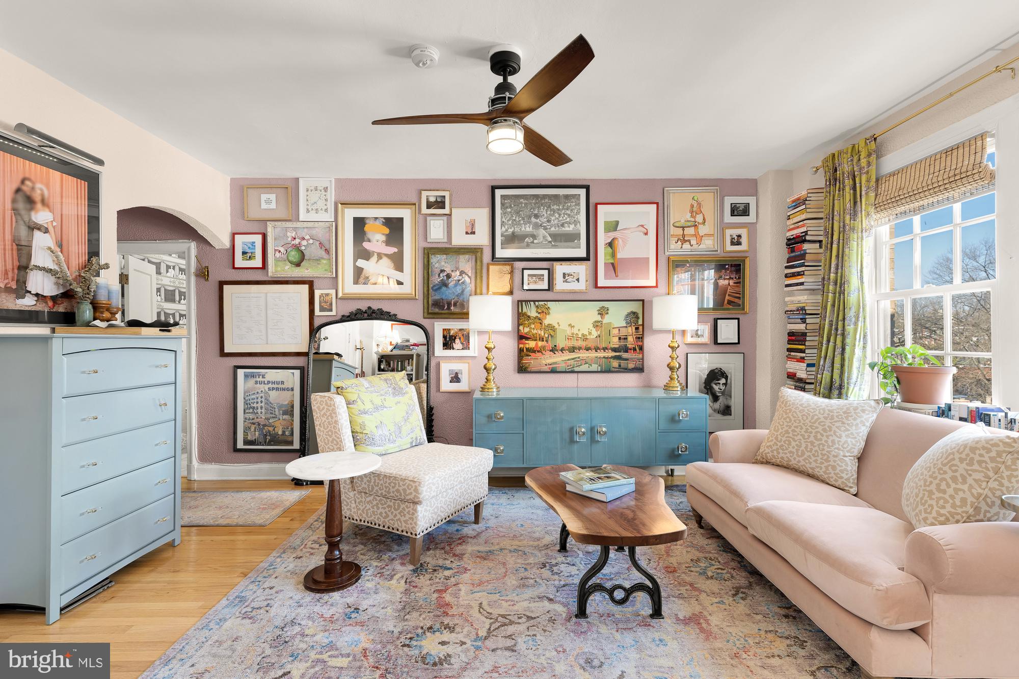 2040 Belmont Road Northwest, Unit 628 Washington, DC 20009 - Photo 2 of 19 a living room with furniture a rug and paintings on the wall