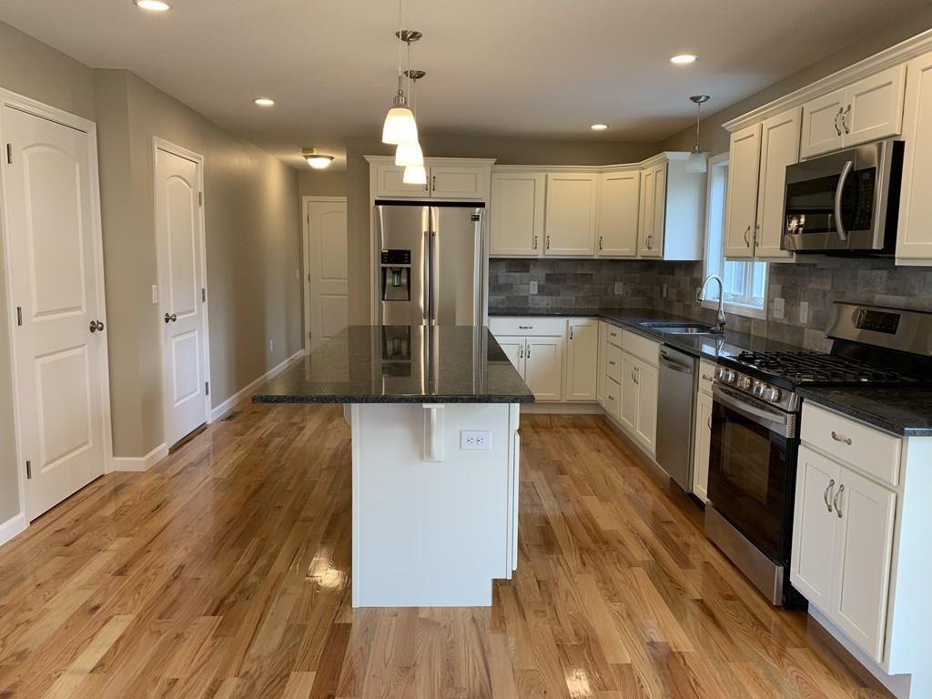 45 Delaware Avenue Springfield, MA 01119 - Photo 5 of 19 a kitchen with kitchen island a counter top space appliances and cabinets
