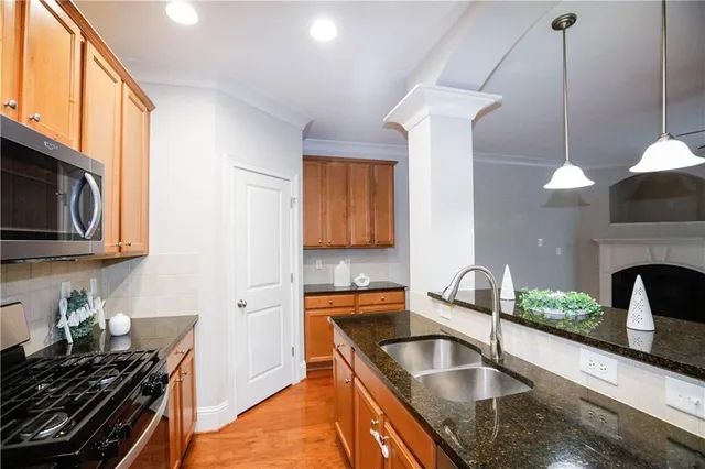 a kitchen that has a sink and a stove