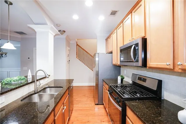 a kitchen with granite countertop a stove and a sink
