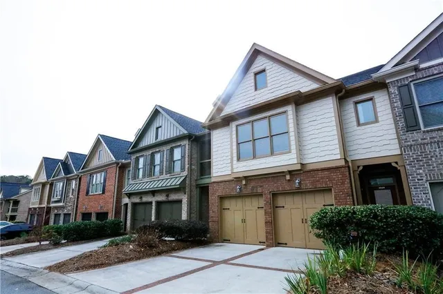 a view of a white building among the street with palm trees
