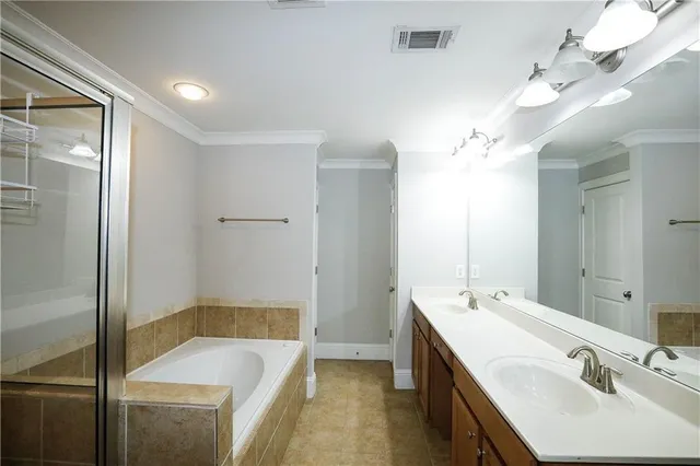 a bathroom with a tub sink and mirror