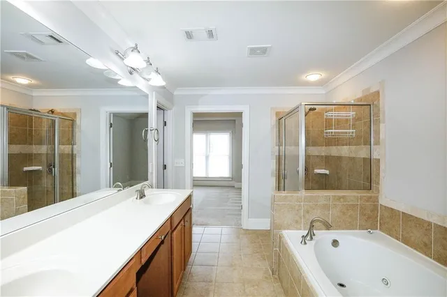 a spacious bathroom with a tub sink shower and mirror
