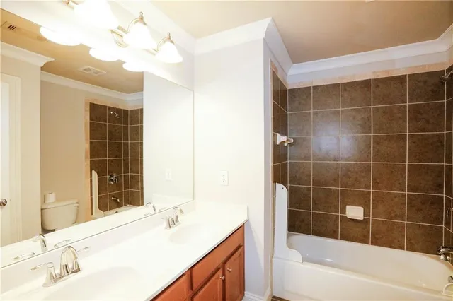 a bathroom with a bathtub sink and mirror