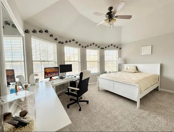 a bedroom with a bed and a desk