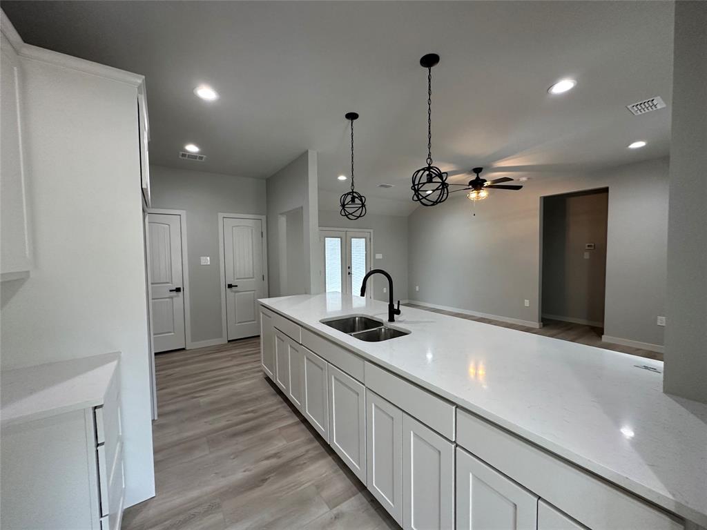 317 North Clark Street Comanche, TX 76442 - Photo 11 of 35 a kitchen with sink and refrigerator