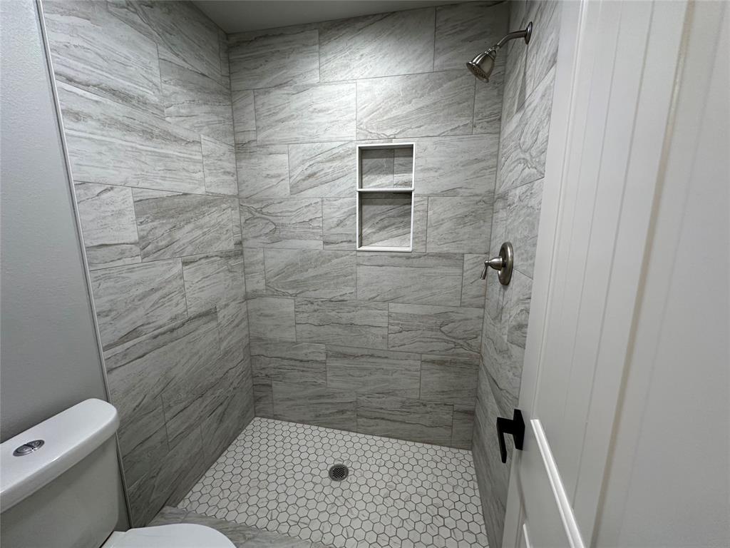317 North Clark Street Comanche, TX 76442 - Photo 24 of 35 a bathroom with a toilet and a shower