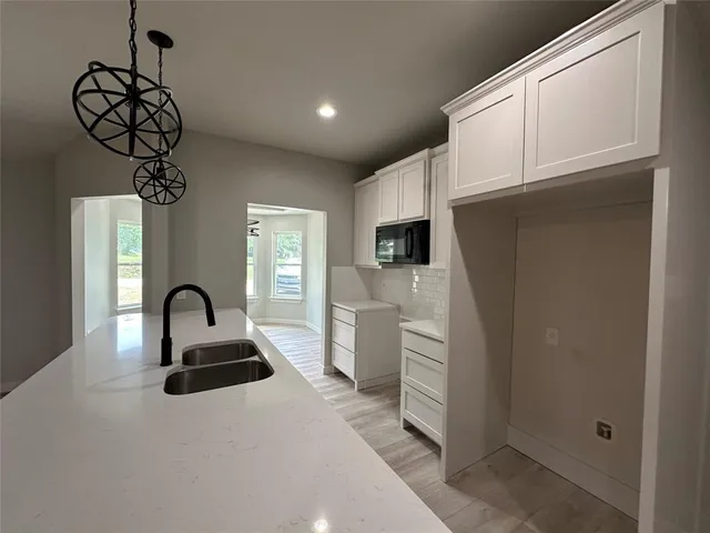 a kitchen with a sink and refrigerator