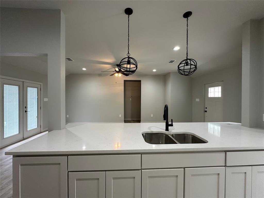 317 North Clark Street Comanche, TX 76442 - Photo 7 of 35 a kitchen with a sink and refrigerator