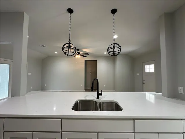 a view of a room with stainless steel appliances granite countertop furniture and wooden floor