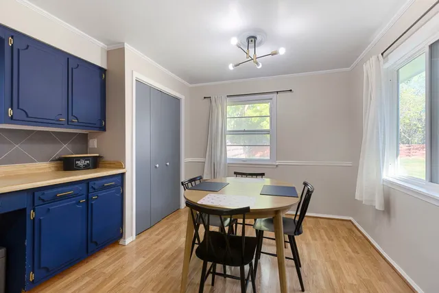 a view of a dining room with furniture and window